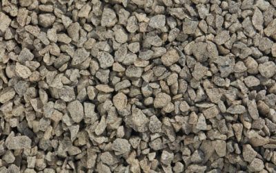 Brown gravel, close-up view. Rough, textured stones fill the frame, varying in size and shade.