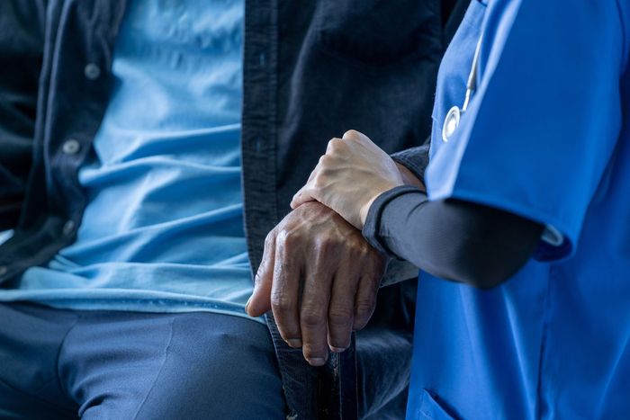 Nurse Holding Old Man's Hand — Nashville, TN — Nashville Healthcare Center