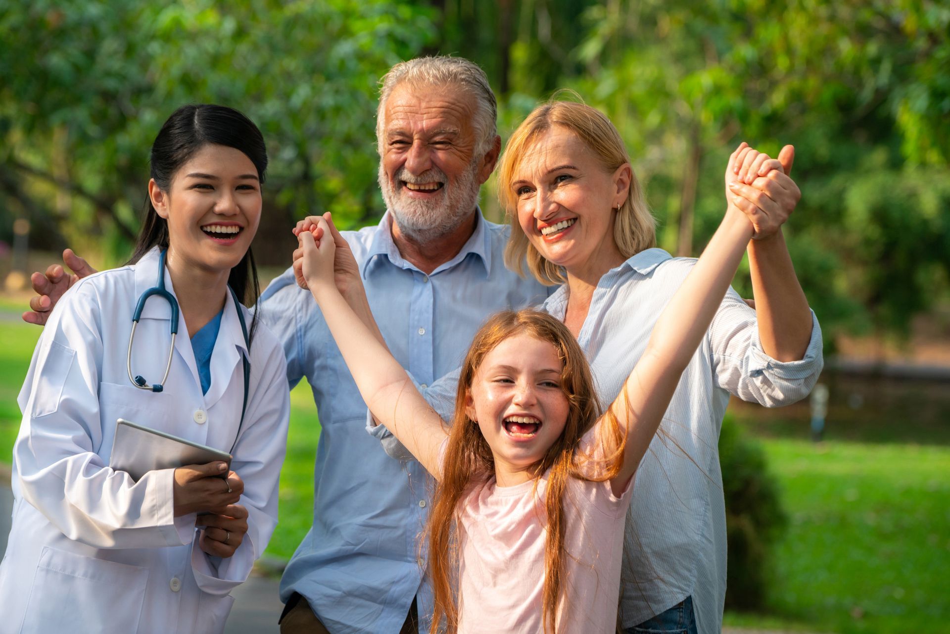 Happy healthy family and doctor talking in park. Happy healthy family and doctor talking in park.