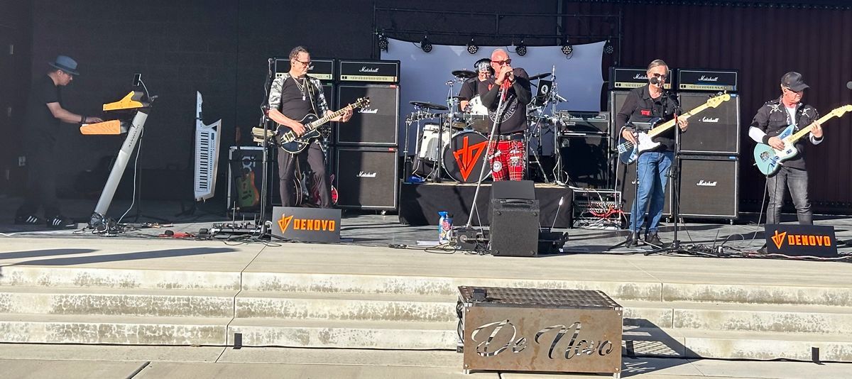 A band is playing on a stage with a banner that says Myer's Morturary