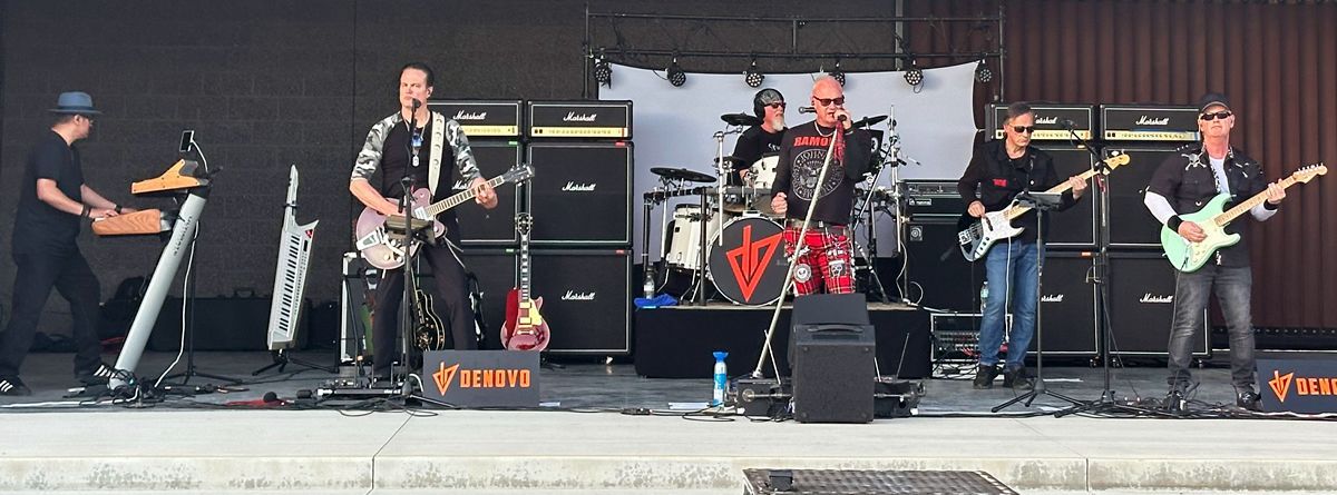 A band is playing on a stage with a banner that says Myer's Morturary