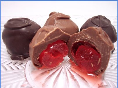 A glass plate topped with chocolate covered cherries