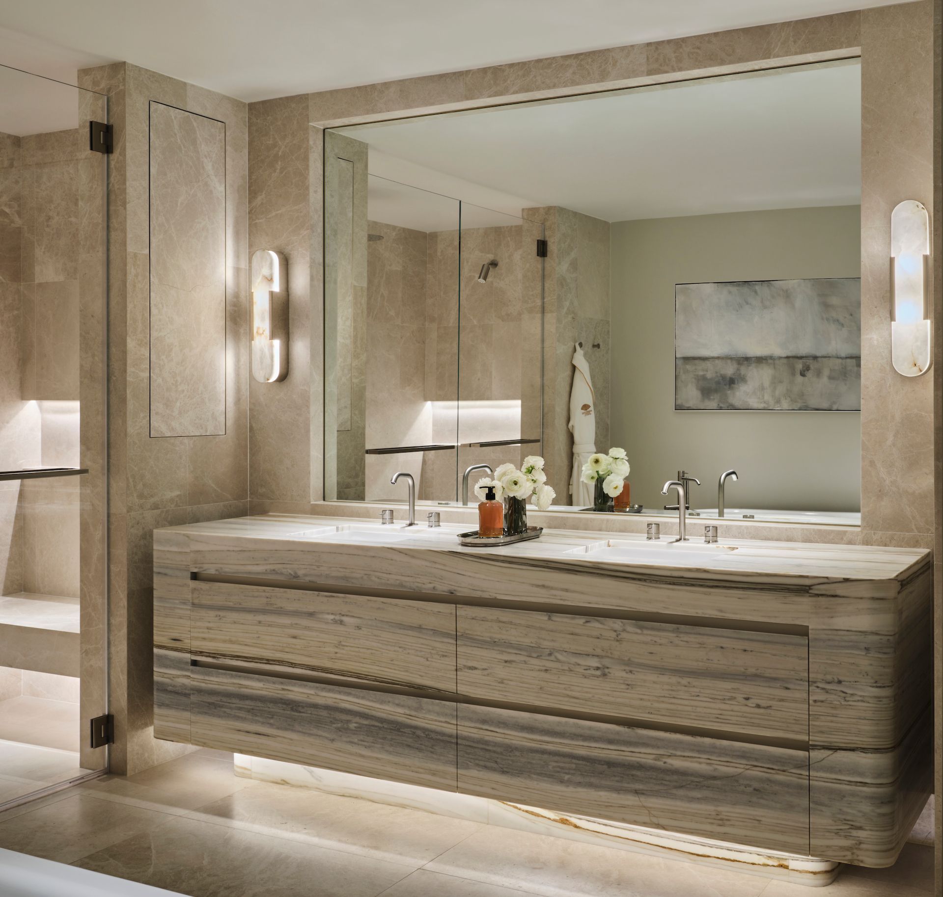 A bathroom with two sinks and a large mirror