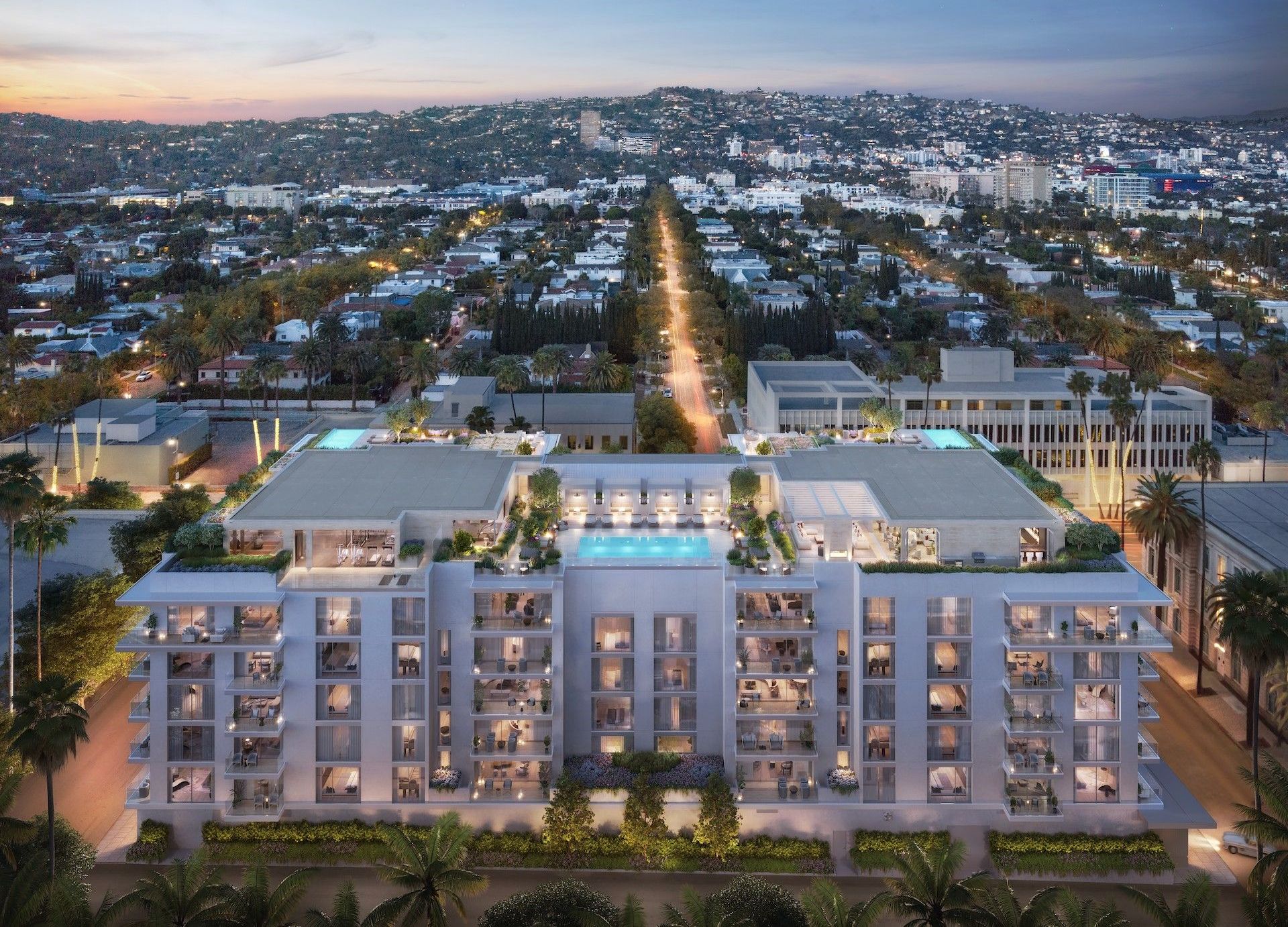 An aerial view of a building with a pool in the middle