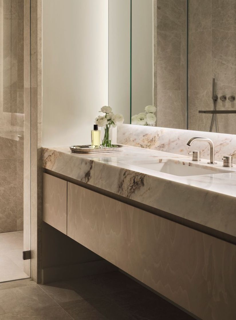 A bathroom with two sinks and a large mirror