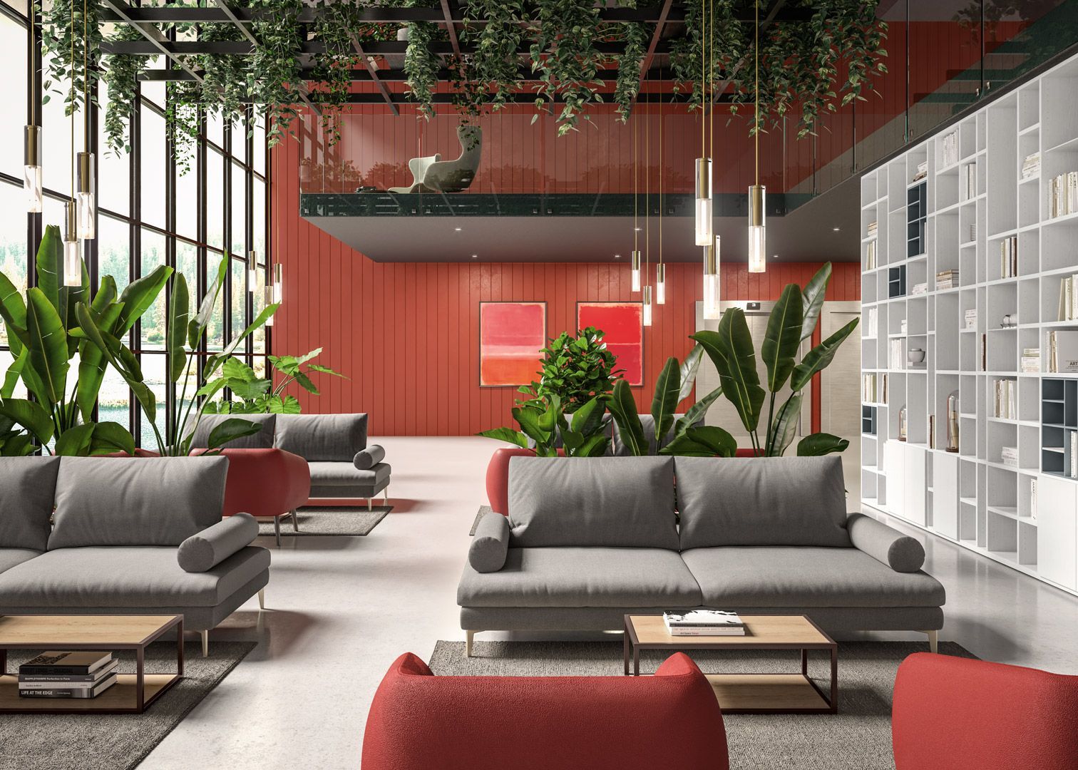 Un moderno ufficio con pareti rosse, divani grigi, piante da interno e un piccolo soppalco.
