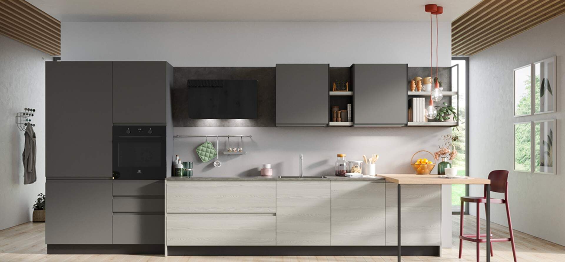 Cucina moderna con mobili grigi, forno e bancone in legno chiaro con tavolino e sgabelli.