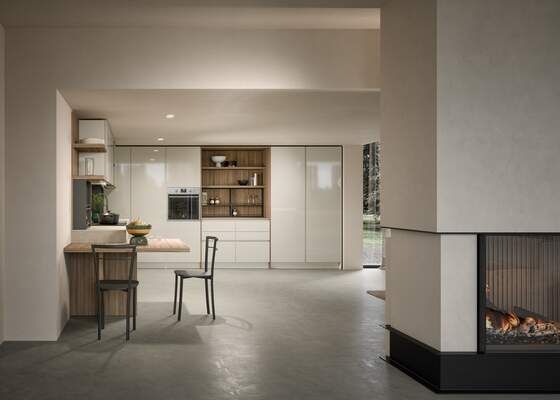 Cucina moderna con mobili chiari e camino in uno spazio dai toni neutri.