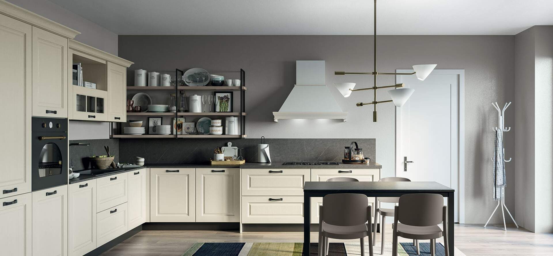 Cucina color crema con paraschizzi grigio, cappa in acciaio inossidabile e tavolo scuro.