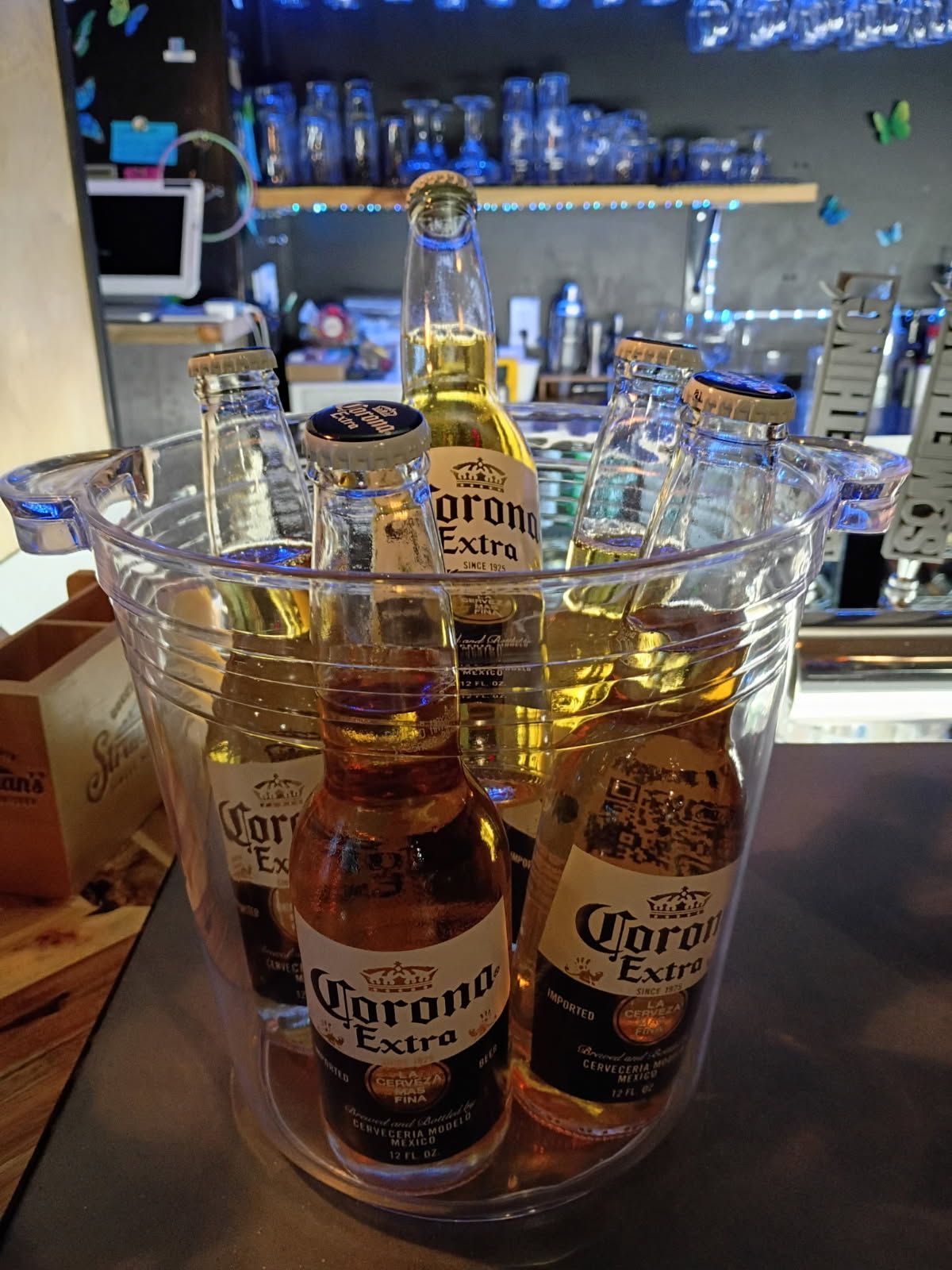 Bartender pouring beer from a tap into a glass at a bar.