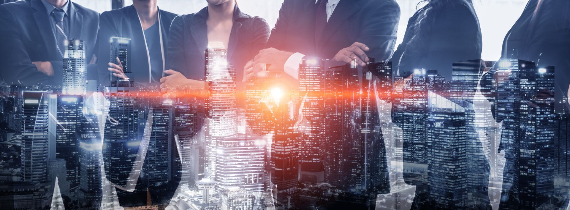 A group of wholesale distribution business people standing next to each other in front of a city skyline.