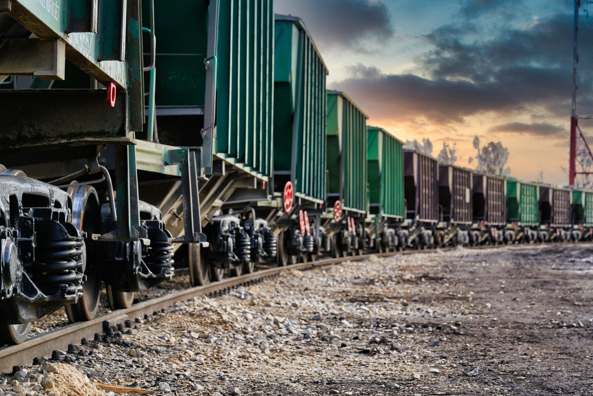 A train is sitting on the tracks in a train yard.