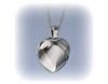A silver heart-shaped locket pendant with a smooth, polished finish hanging from a chain against a light blue background.