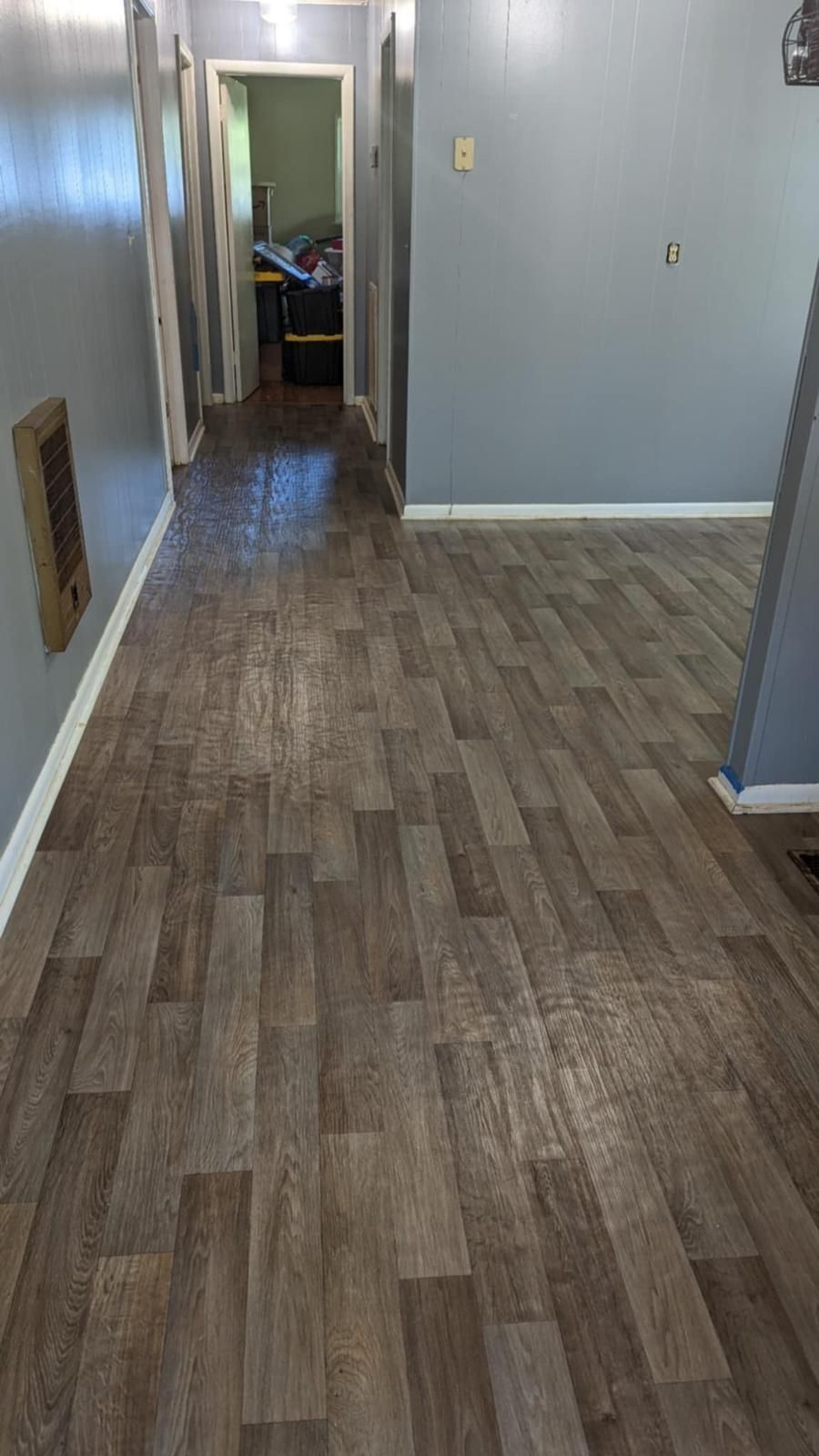 A hallway with a wooden floor in a house.