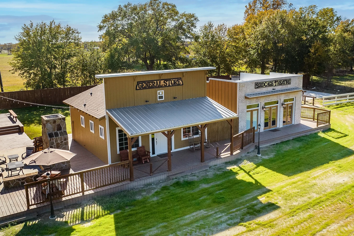 An aerial view of a building in the middle of a grassy field.