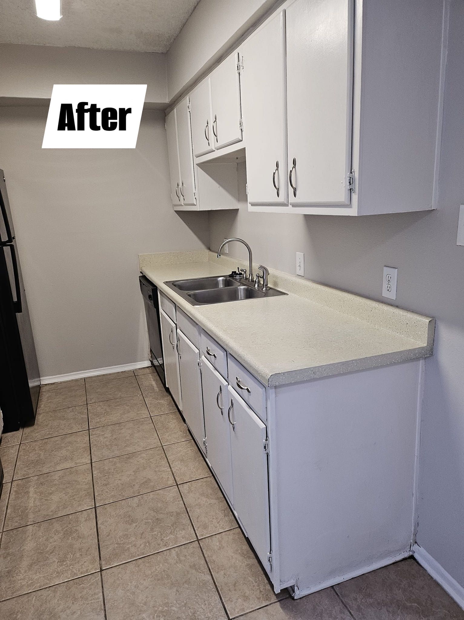 A kitchen with white cabinets and granite counter tops and a sign that says after