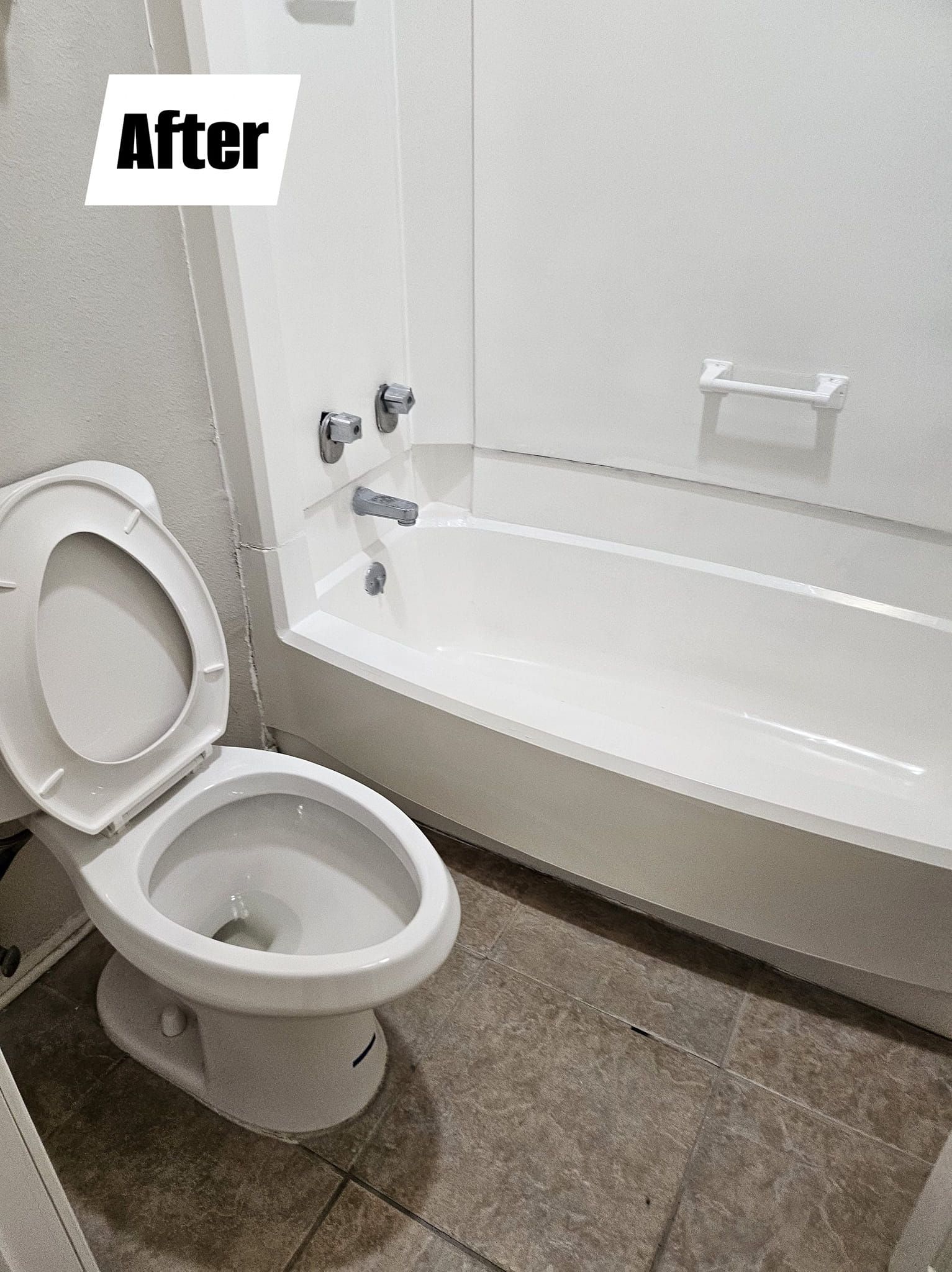 A bathroom with a toilet , bathtub and shower.