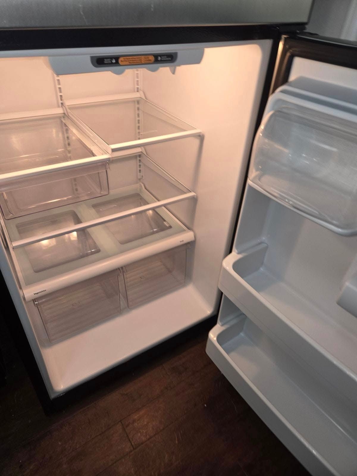 The inside of an empty refrigerator with the door open