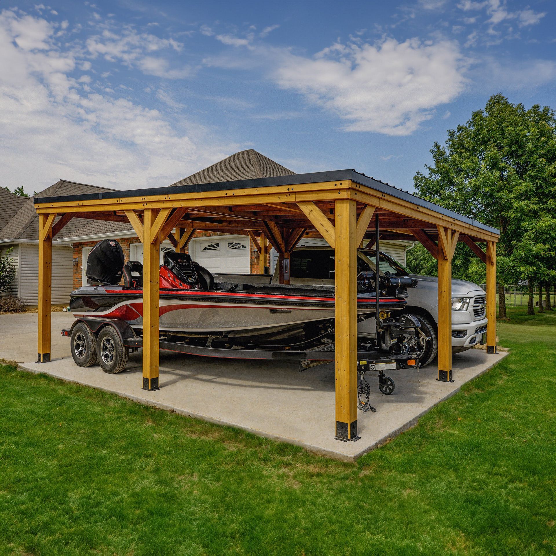 Wooden carport sheltering a boat on a trailer and a pickup truck on a concrete pad in a yard.
