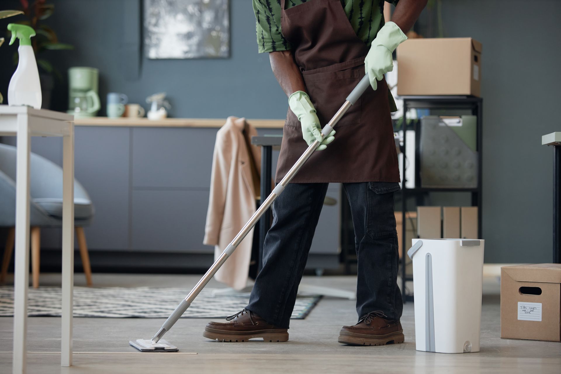 man mopping the floor of a home office