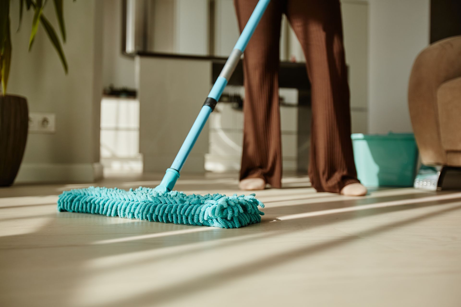 a woman mopping the apartment floor