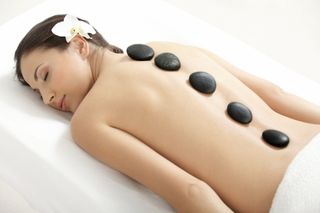 womens receiving hot stone massage