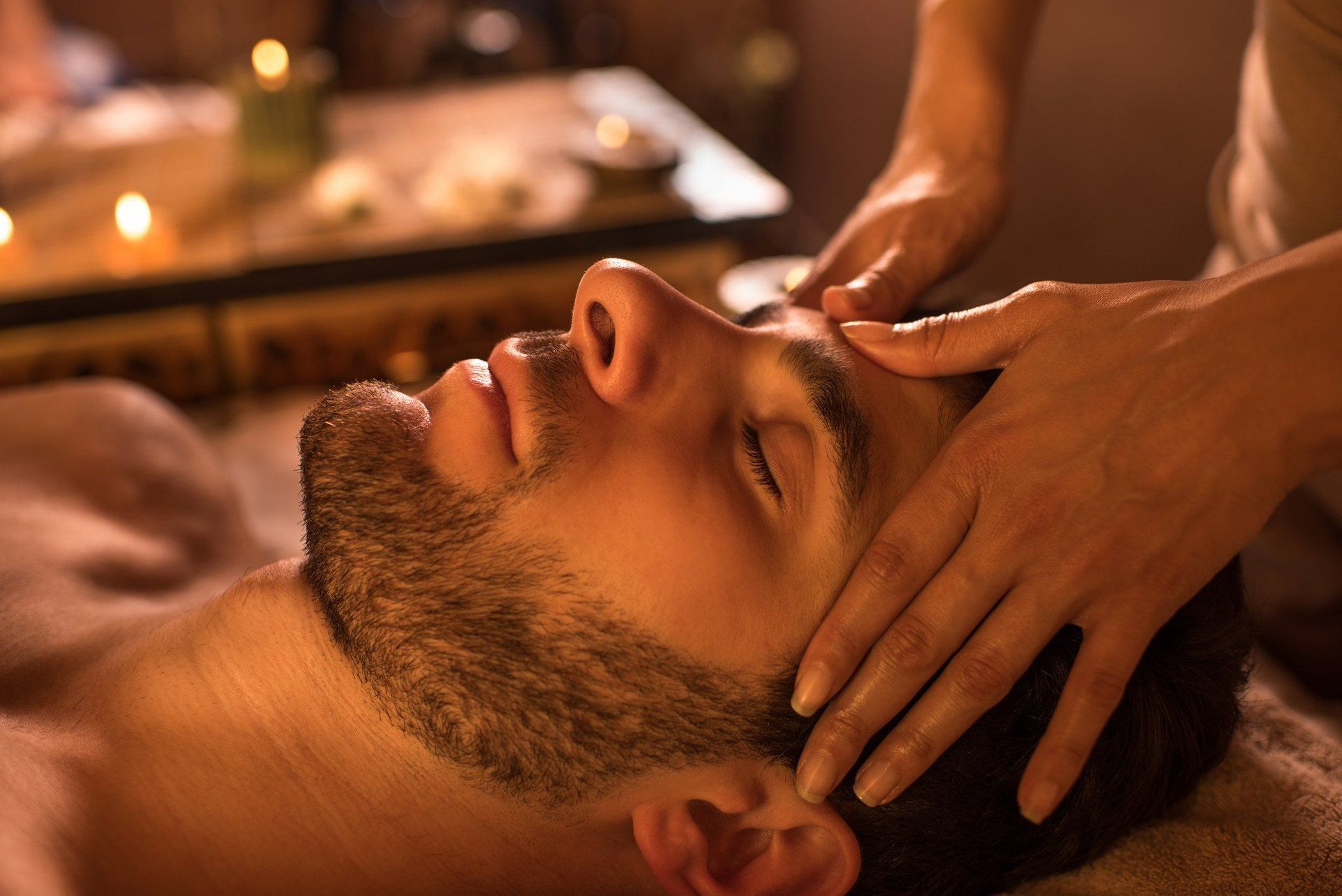 man receiving facial massage