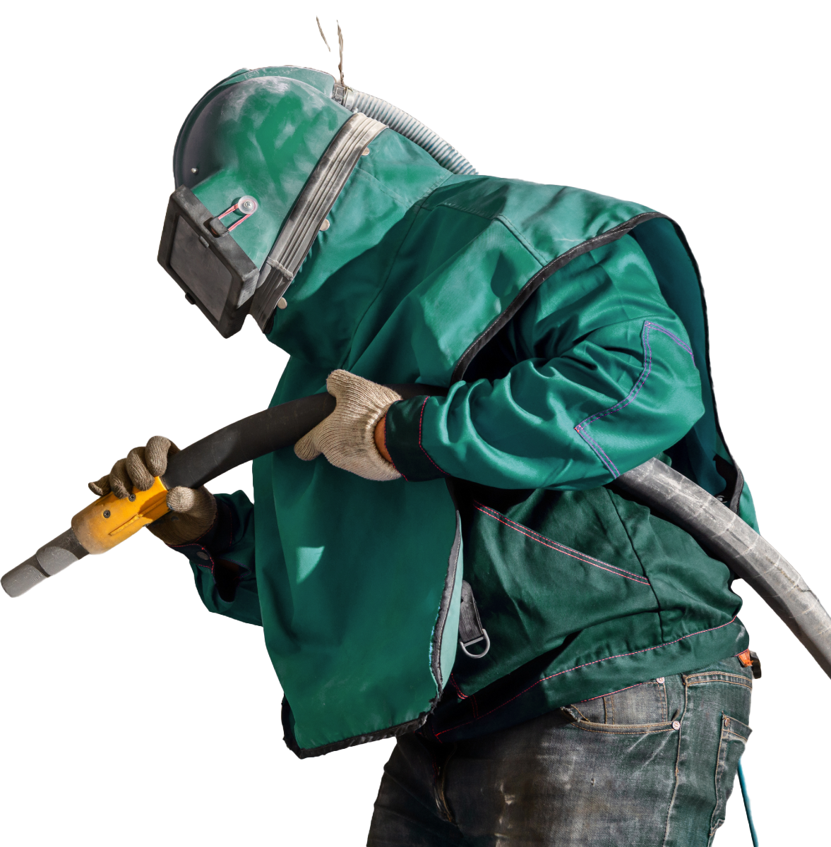 A man in a green jacket is sandblasting with a hose.