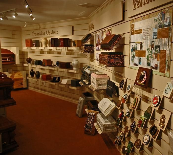 A funeral home display showcasing urns, keepsakes, and cremation options.