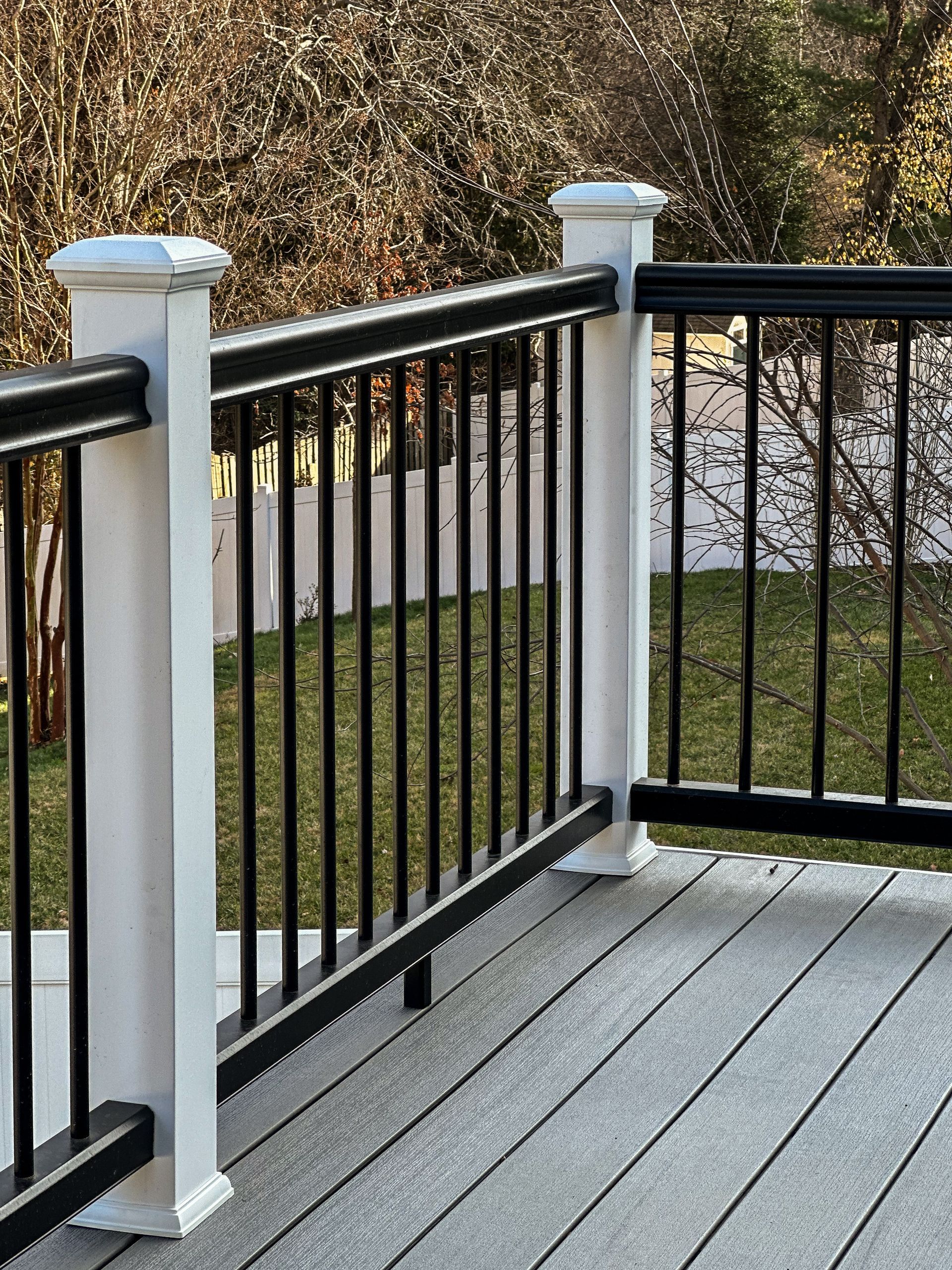 Composite deck with black railing and white posts.