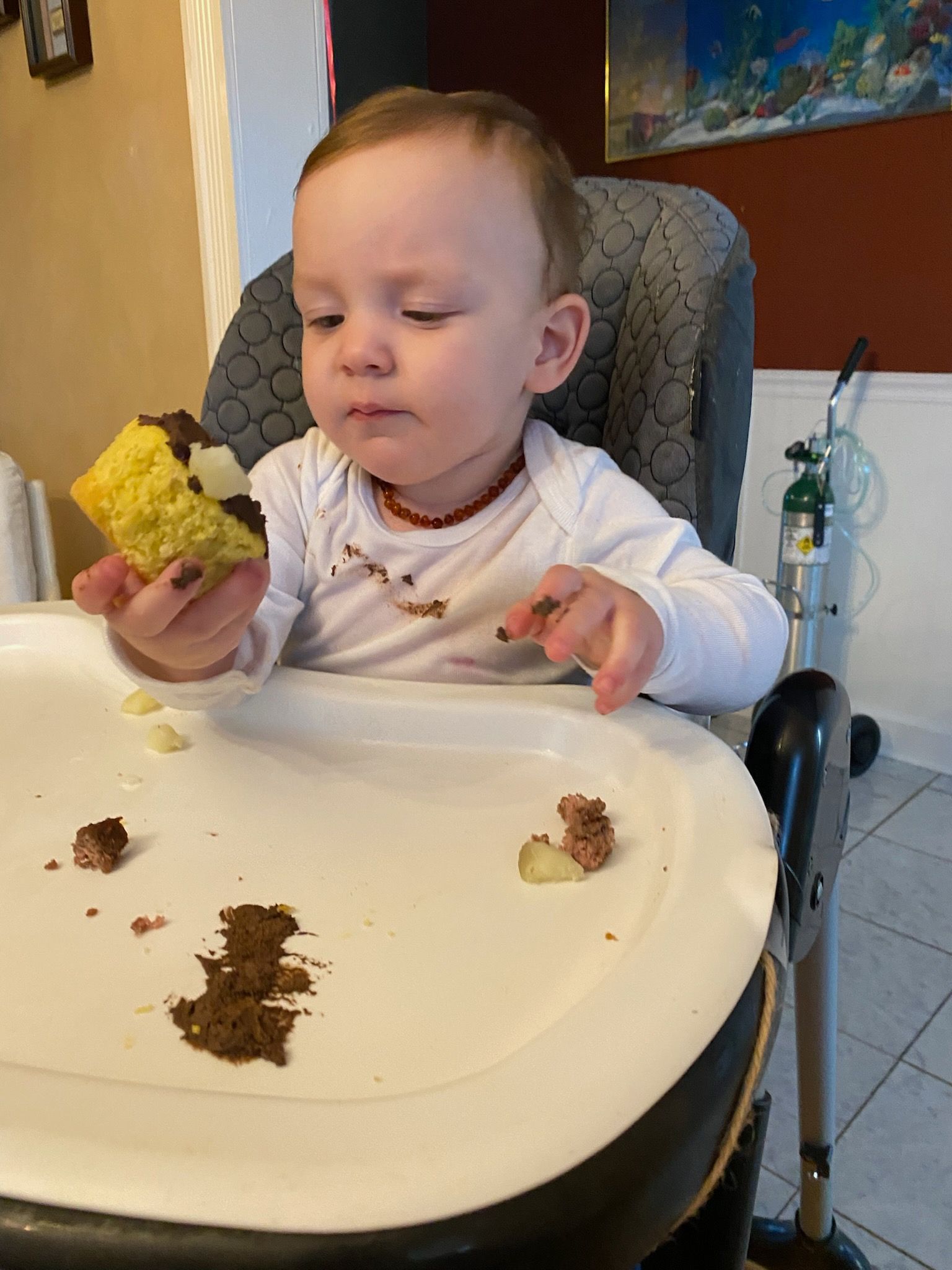 Basket of colorful vegetables and fruit with dumbbells and a measuring tape, suggesting healthy eating and exercise.