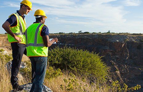 Two male workers surveyors at mining site