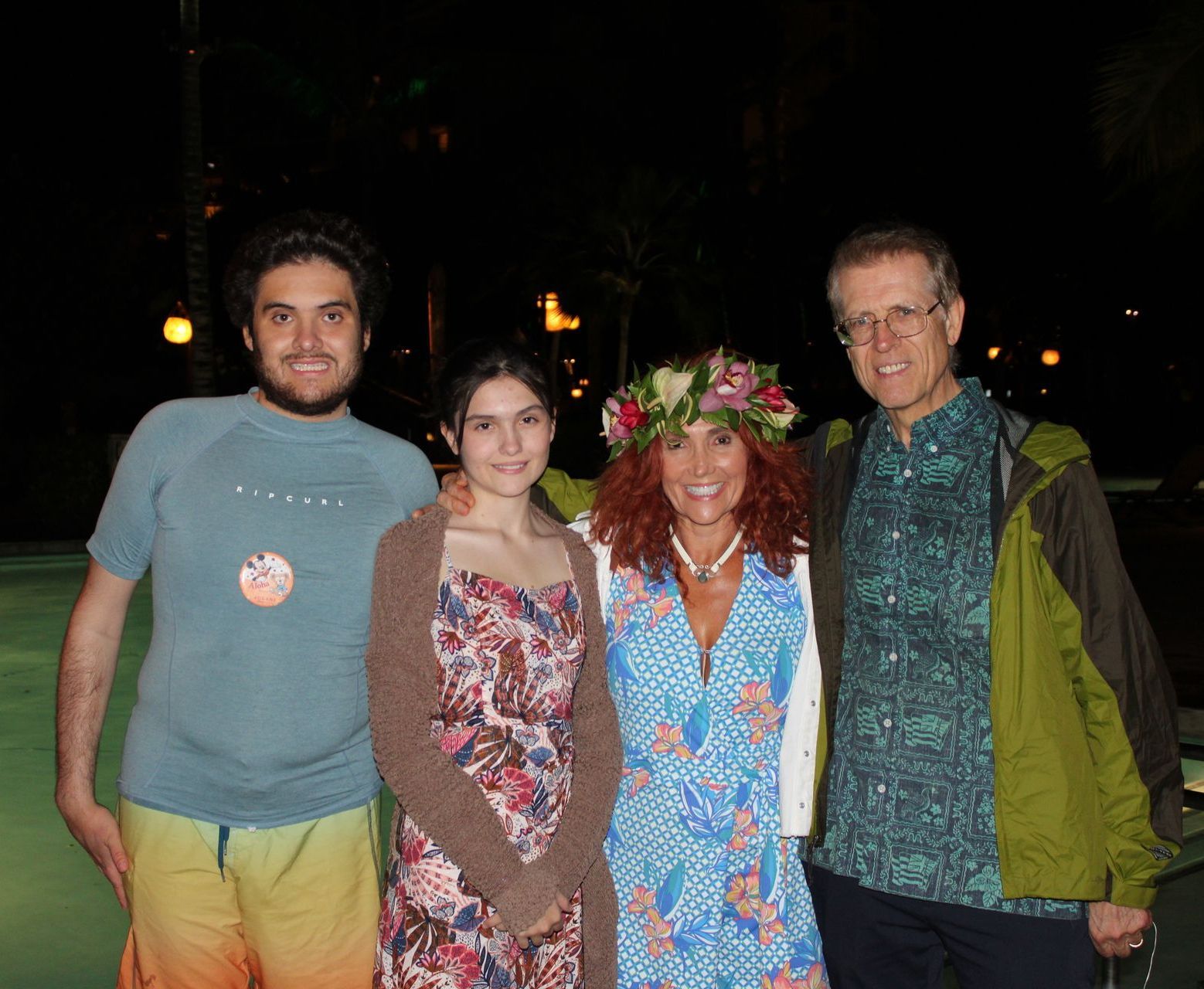 A group of people posing for a picture with one wearing a flower crown