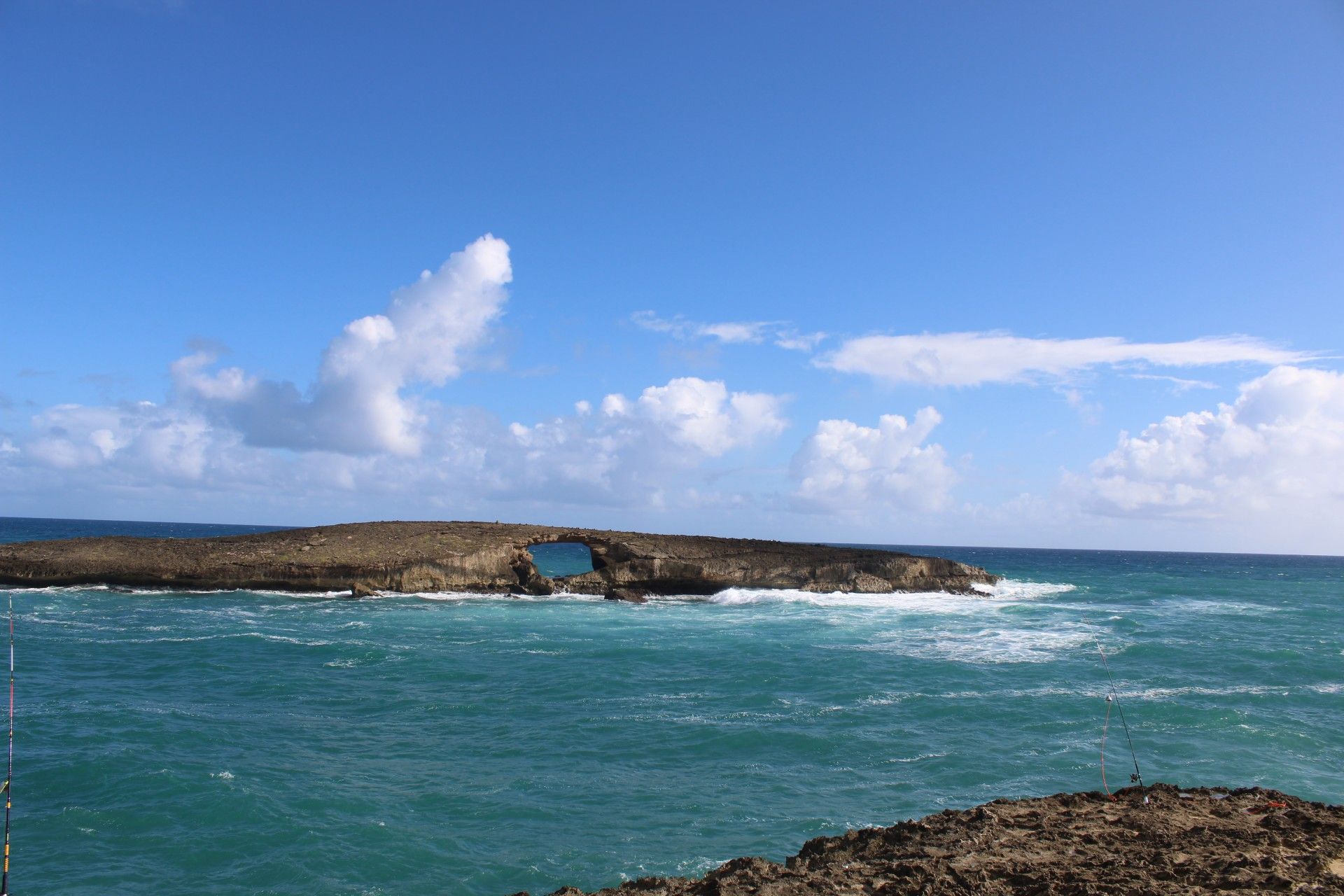 A rocky outcropping in a blue sea