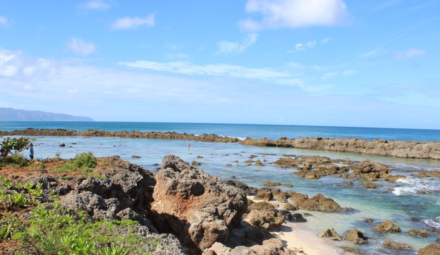 People walk in tide pools