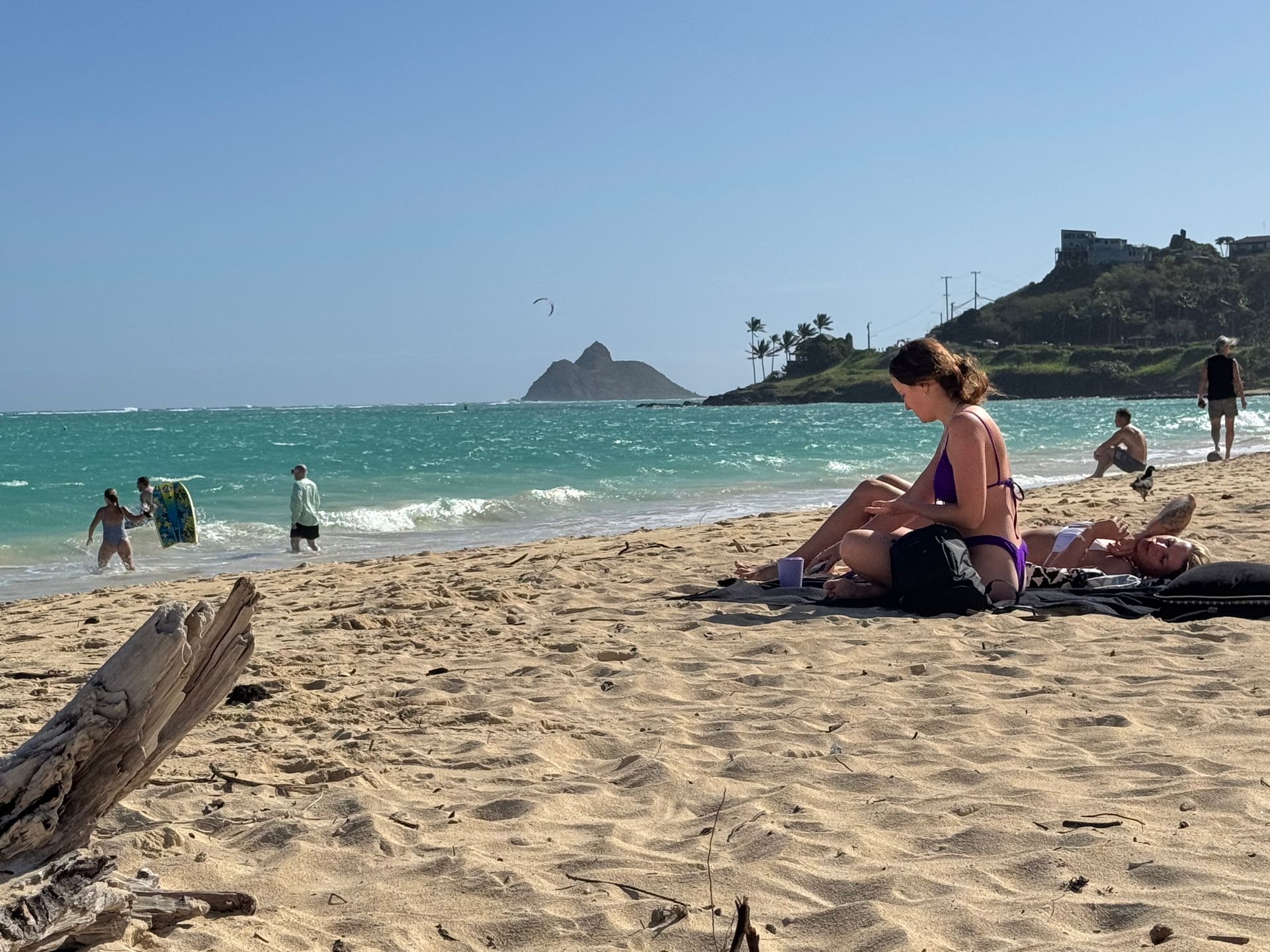 A person in a bikini relaxes on a beach