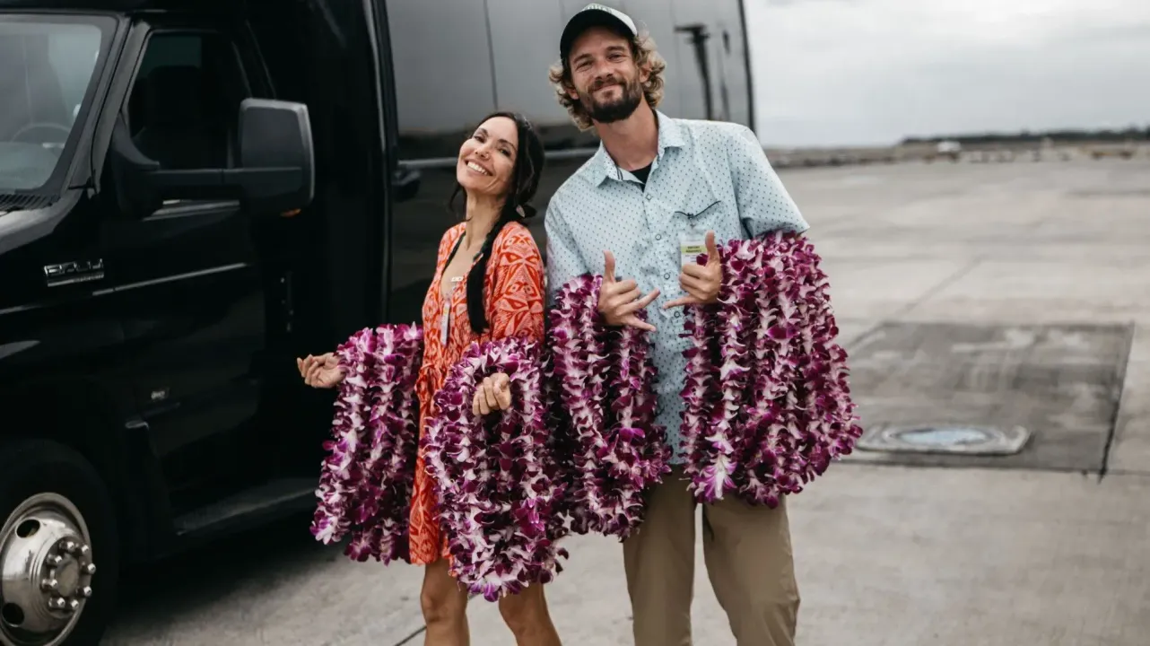 Holding Hawaiian lei necklace at the airport