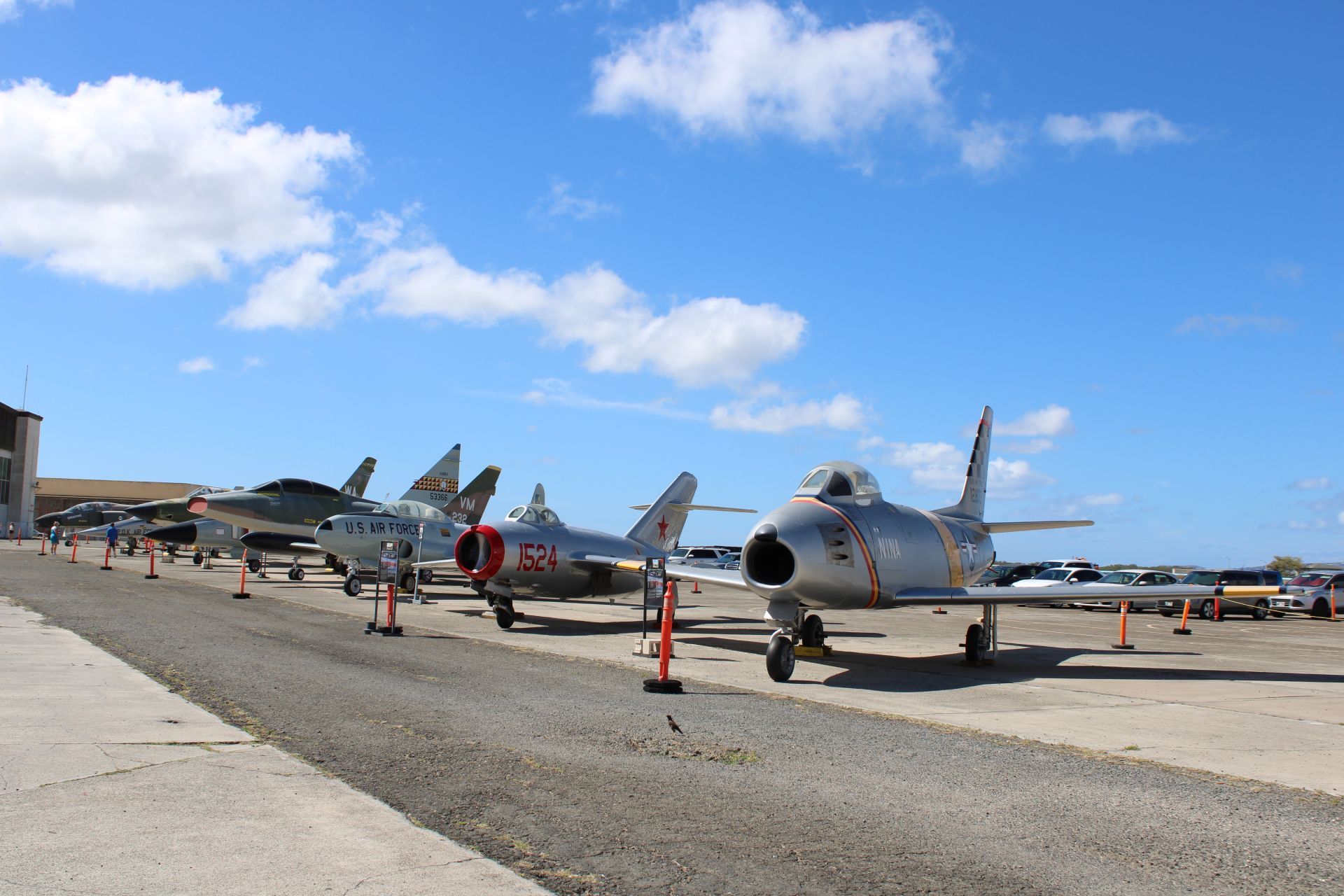 A row of fighter jets are parked on a runway