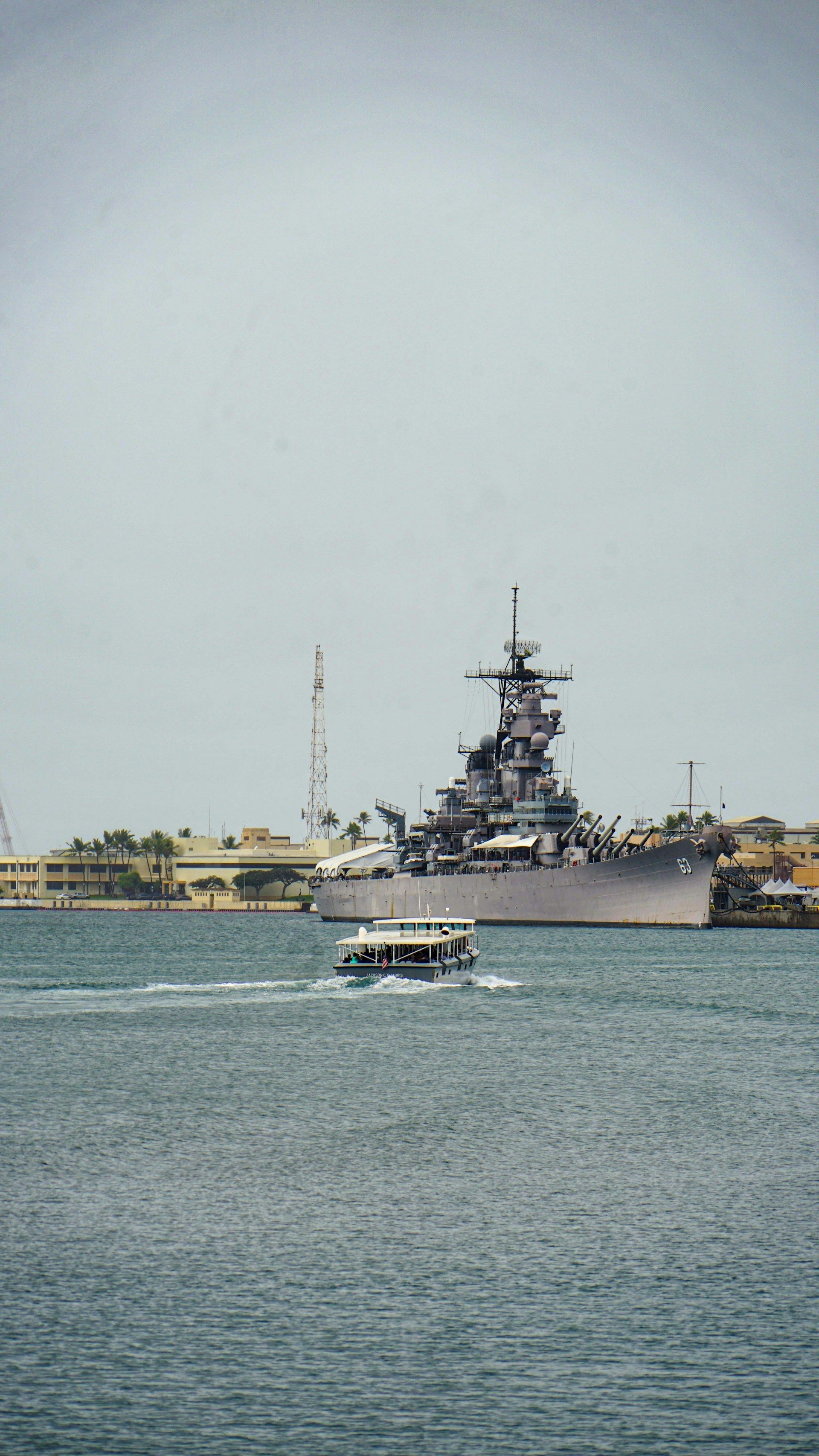 Small boat driving towards the USS Missouri battleship