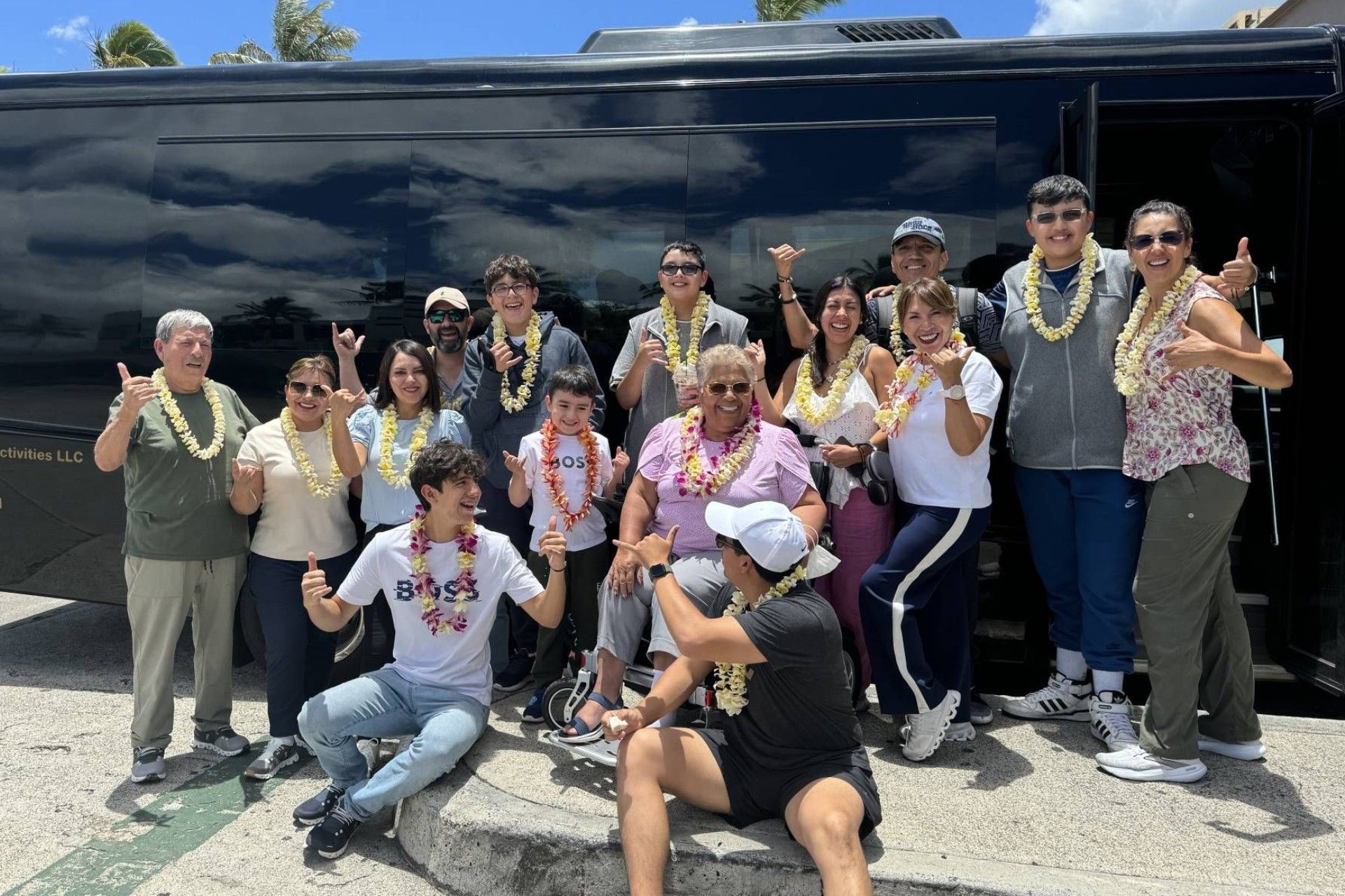 A group of people are posing for a picture in front of a bus.