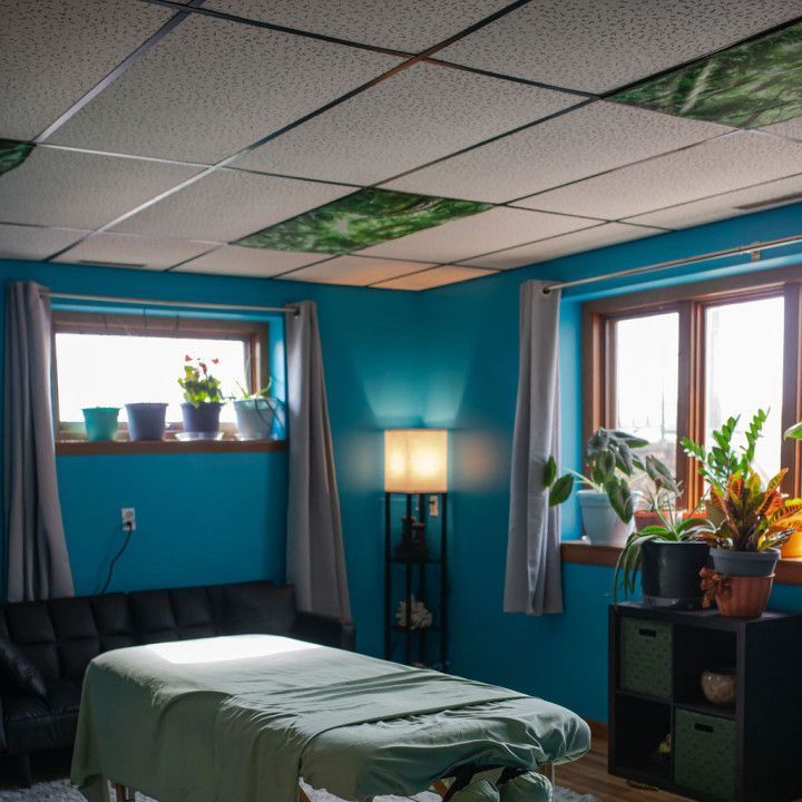 A massage table in a room with blue walls