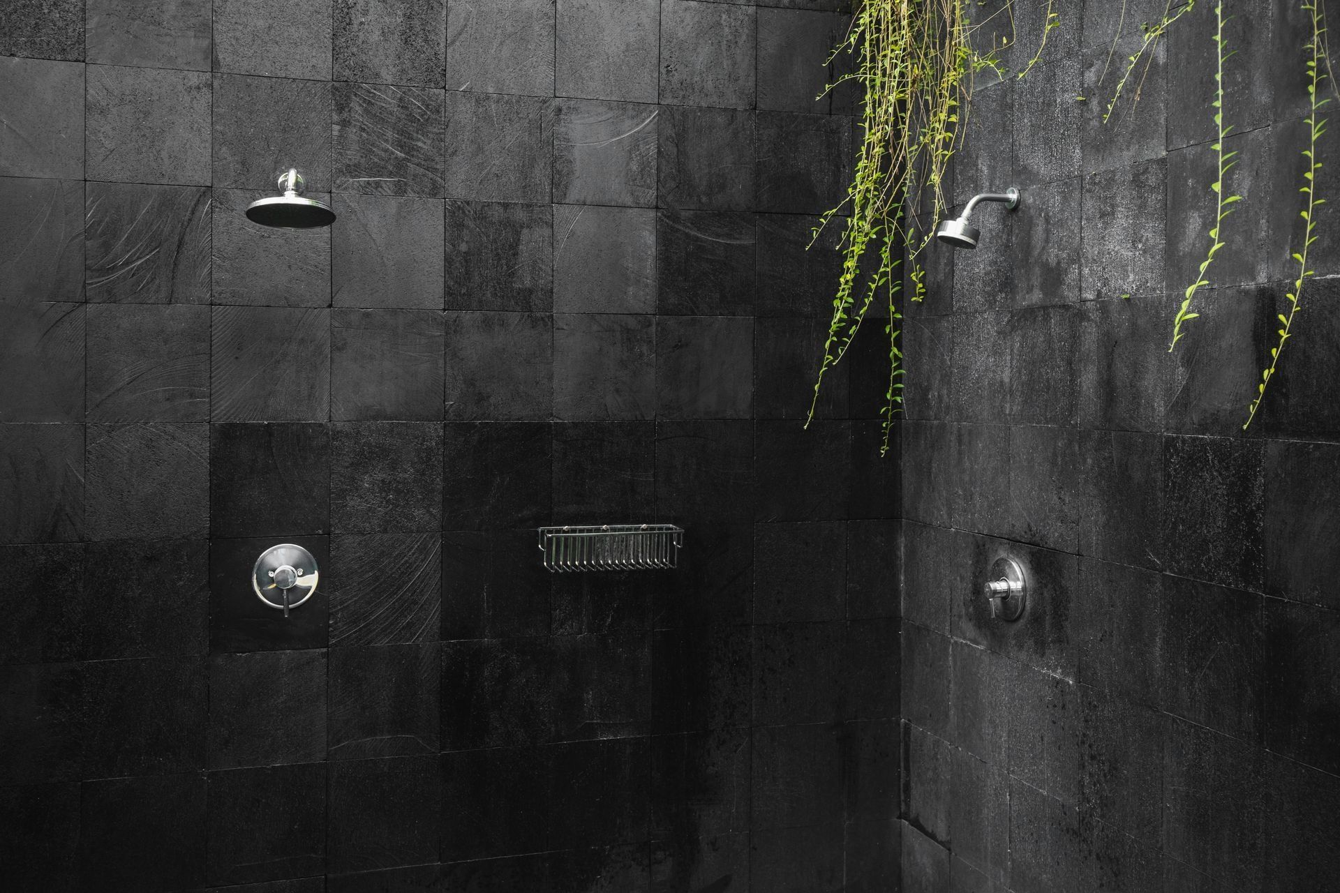 A black and white photo of a shower with two shower heads. A black and white photo of a shower with two shower heads.