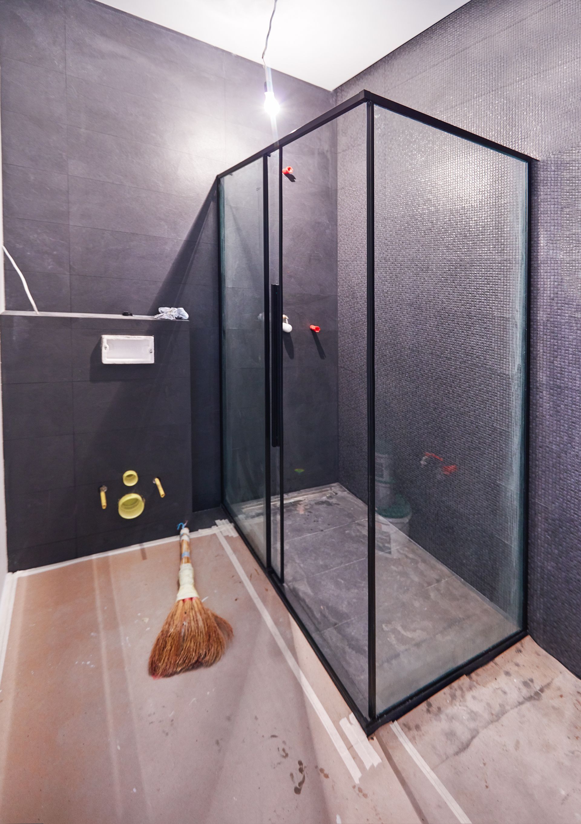 Residential bathroom remodeling project featuring a tub-to-shower conversion in progress. Residential bathroom remodeling project featuring a tub-to-shower conversion in progress.