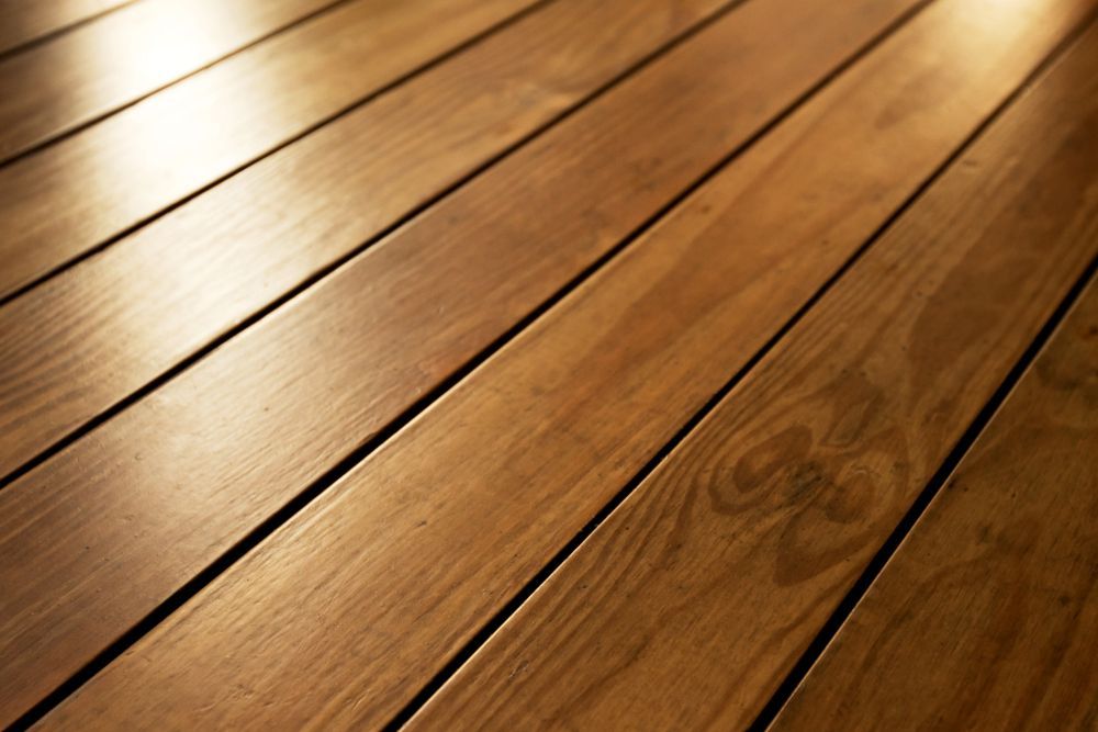 Close-up of Warm-toned Hardwood Floor Planks — Dachboe Your Handyman In Townsville, QLD