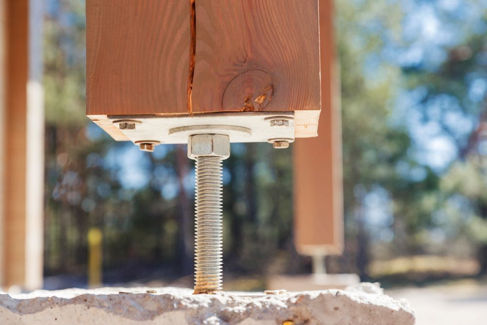 Wooden Post Anchored to a Concrete Base With Adjustable Metal Hardware — Dachboe Your Handyman In Townsville, QLD