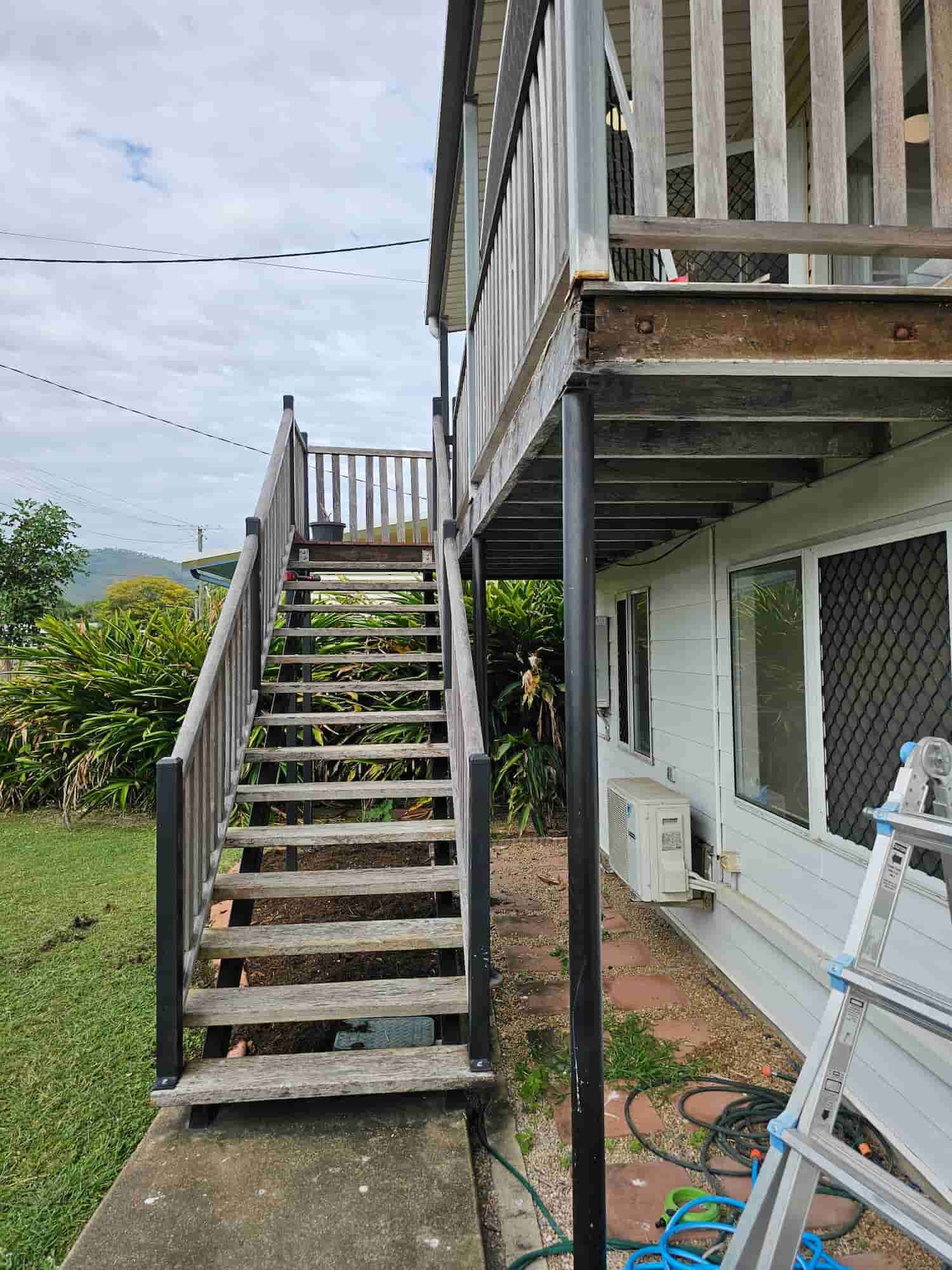 A Wooden Deck With Stairs Leading Up To The Second Floor Of A House — Dachboe Your Handyman in Townsville, QLD