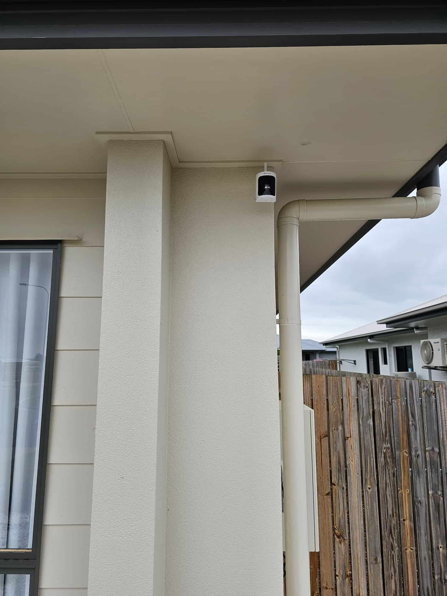 A White House With A Gutter And A Camera On The Side Of It — Dachboe Your Handyman in Ayr, QLD