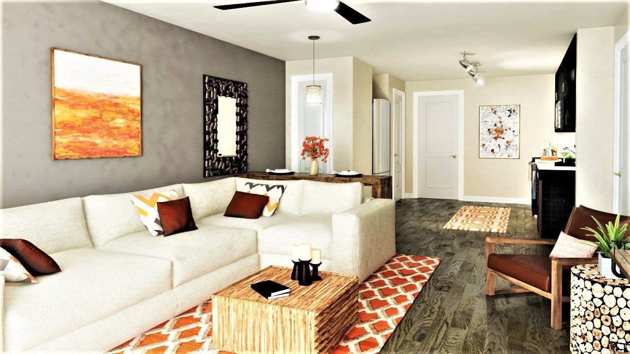 Interior living room with beige sectional sofa, wood coffee table, and open kitchen.