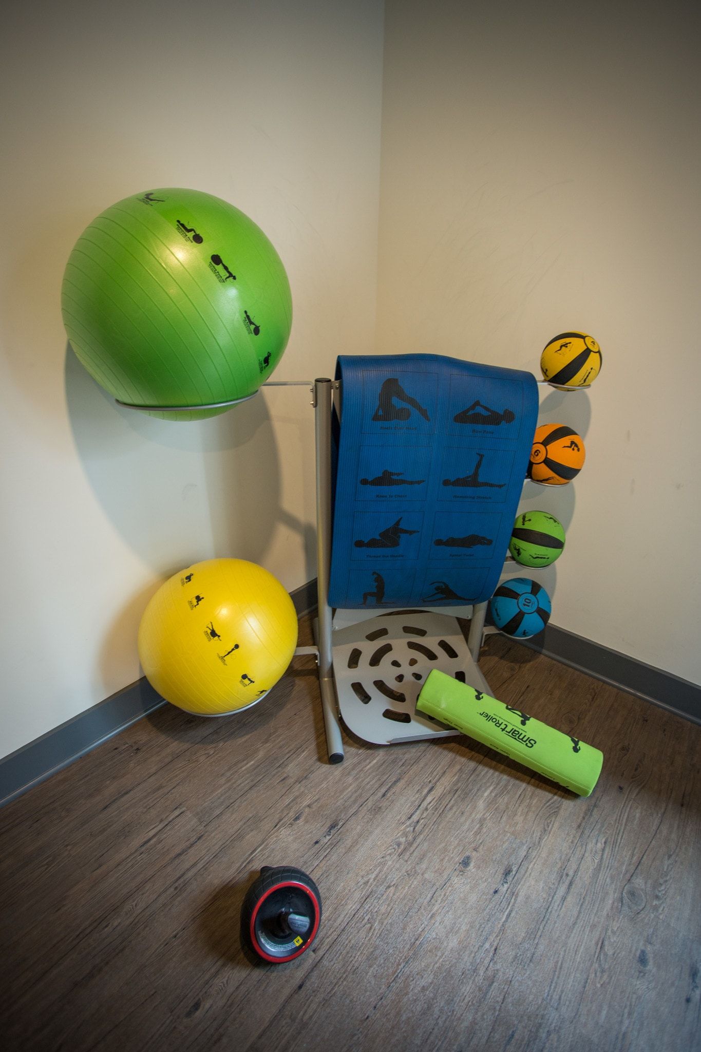 Small in-building fitness area with exercise balls, mat and workout equipment.