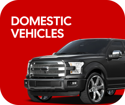 Red square with white text "DOMESTIC VEHICLES" next to a black truck. | Arn's Auto Service